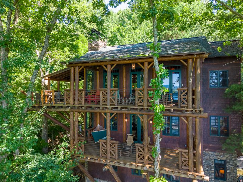 Side of the house showing three tiers of log-railed balconies