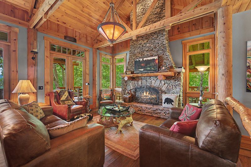 Great room with the stone fireplace and leather sofas