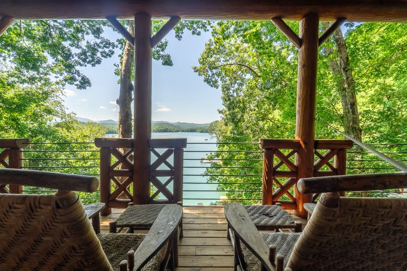 Private balcony off the primary suite looking down at the lake