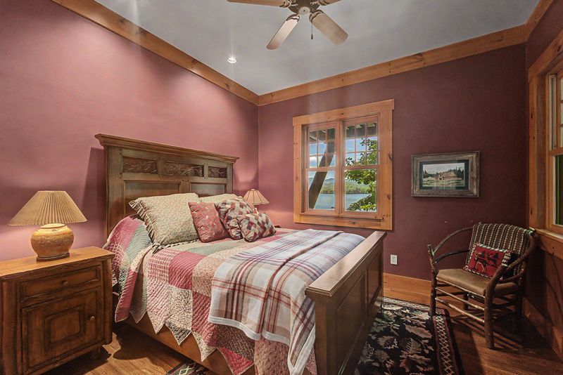 Guest bedroom with a log bed and a window on the lake