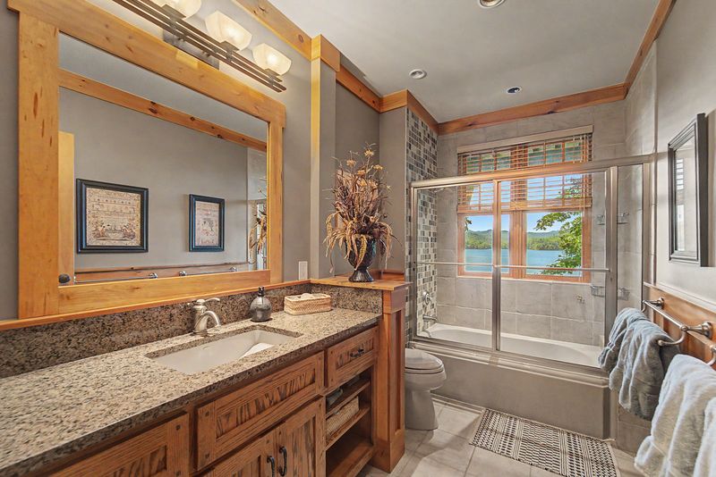 Guest bath with a granite vanity and glass shower