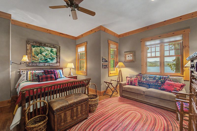 Guest bedroom with a sofa and a window framing the lake