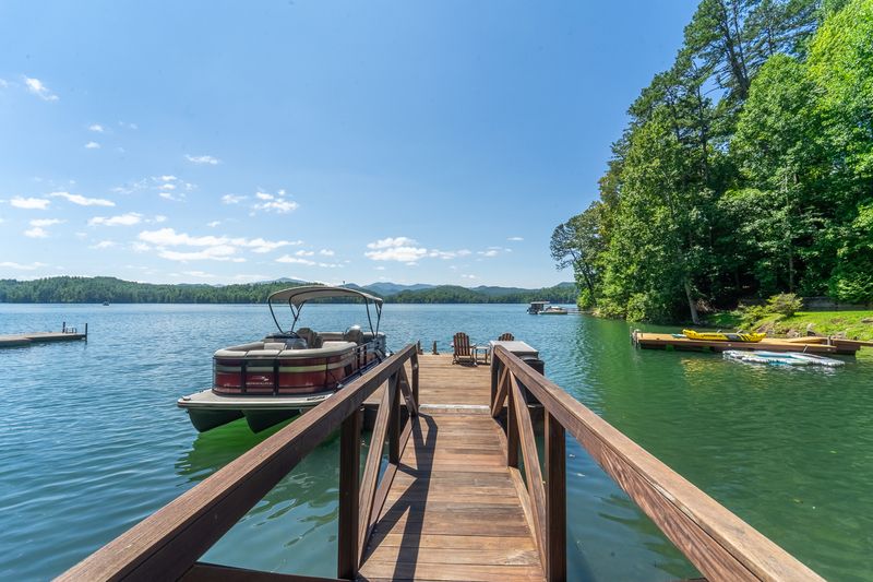 Wooden walkway leading out to the dock and boat